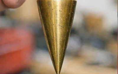 Found this heavy pointed brass weight in my dad’s old toolbox. It has a string attached. What is this?