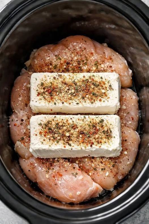 Put raw chicken breasts in the crock pot, top with blocks of cream cheese